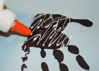 adding glue to handprint