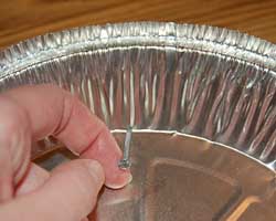 inserting nail to make a hole