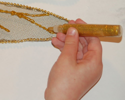 applying gold glitter glue