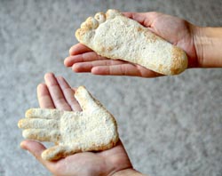 sand cast of child's handprint and footprint