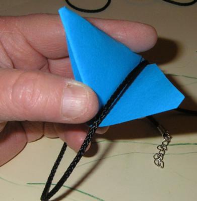 slipping necklace through the triangle